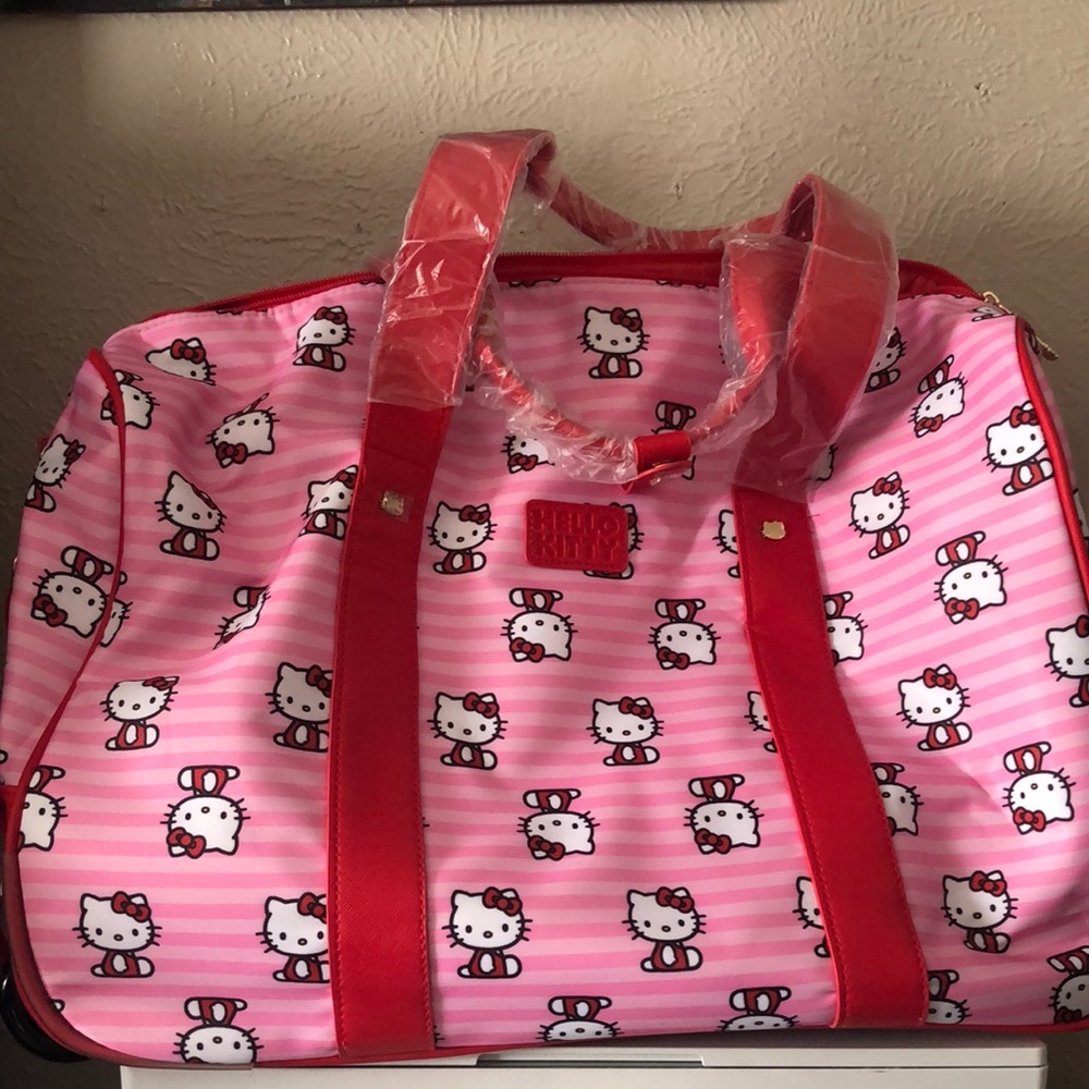 Hello Kitty NWT Rolling Duffle Bag Luggage With Stap and Rollers